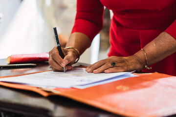 Closeup of a businesswoman signing an official document or contract