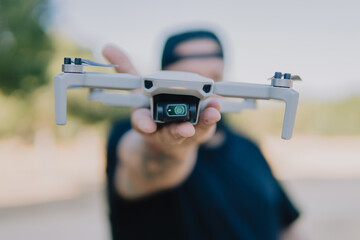 Shallow focus shot of a male holding a drone outdoors