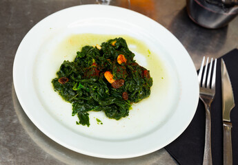 Catalan Spinach served on table with serving pieces