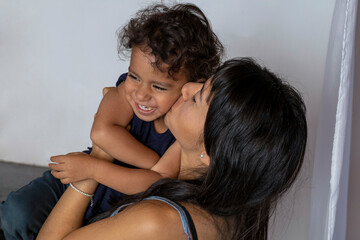 Latin American mom and son share Mother's Day with hugs and affection. Mother's day concept