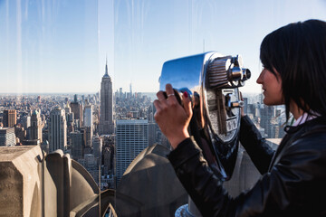 A woman looks at new York cityscape from a rooftop