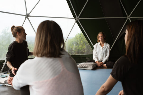 Yoga master giving a theory class to a group