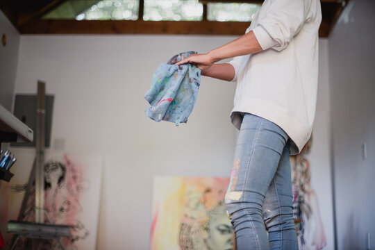 Woman's hands as she washes paint off her hands.