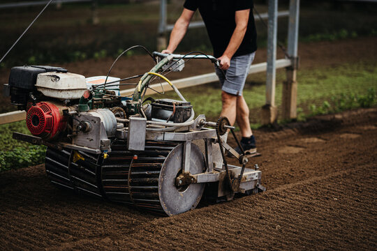 Man working with a farming equipment