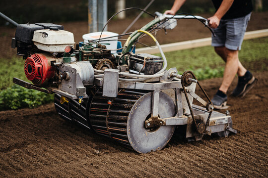 Man working with a farming equipment