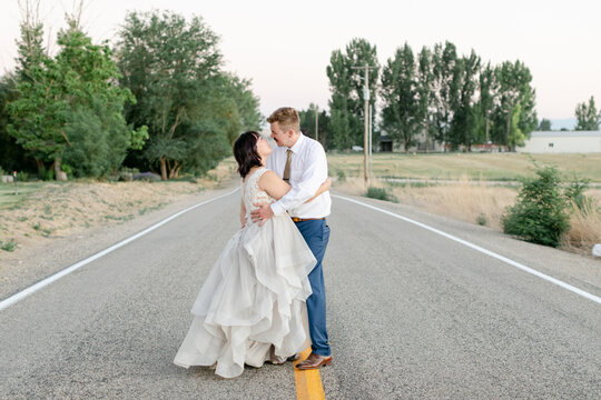 Bride and Groom Embracing in Road