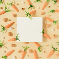 Fototapeta na wymiar Easter pattern made with carrots and easter eggs on bright pastel yellow background. Creative minimal Easter holiday concept spring holiday celebration or idea. Flat lay With writing space