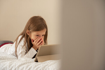 Girl watching shocking video on tablet