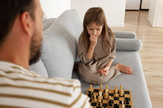 Daughter thinking over chess move