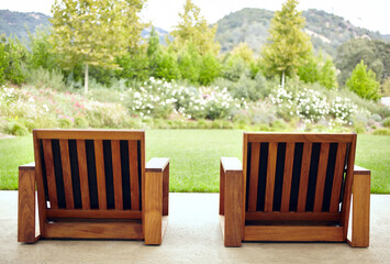 Close-up of two chairs on outdoor lounge patio area with view