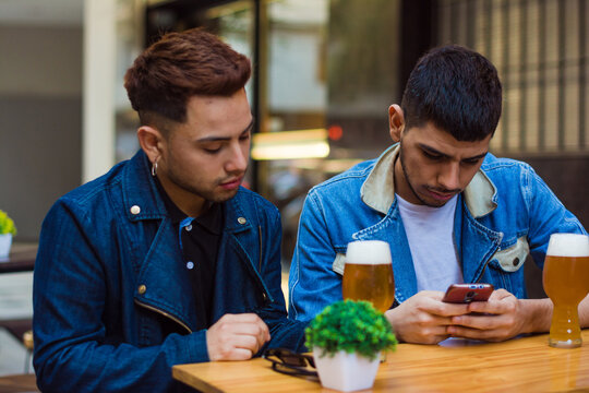 Couple in outdoor bar with beers