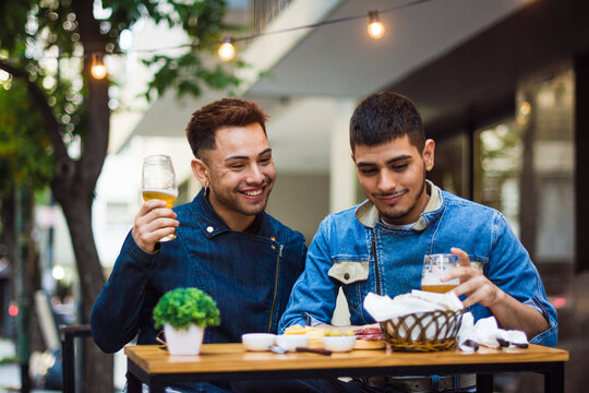 Gay Latino Couple Eating Outside