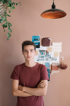 Young Designer In Front Of Colorful Vision Board