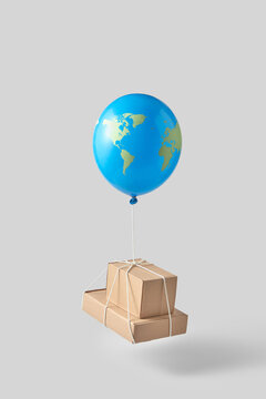 Cardboard boxes levitating on earth shape balloon