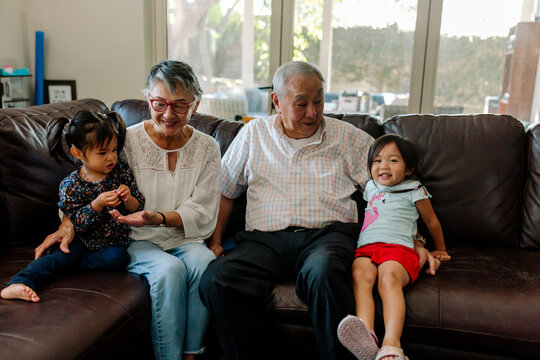 Grandparents On Couch With Granddaughters