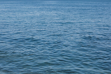Blue sea water. Blue water surface. Blue water background. Ocean waves. Water surface slash. Blue aqua. Color surge