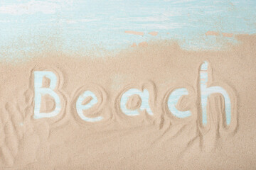 The inscription of the beach on the boards with sand