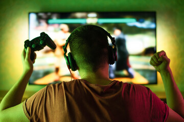 gaming game play tv fun gamer gamepad guy controller video console playing player holding hobby playful enjoyment view concept - stock image