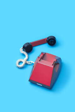 Old fashioned telephone over light blue background
