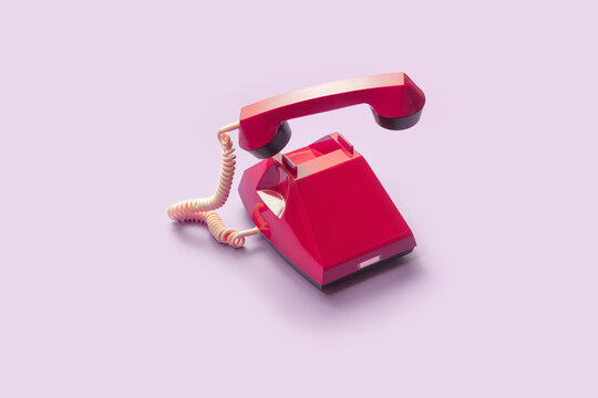 Red vintage telephone with handset off hook