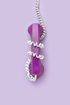 Violet telephone handset with white cable