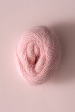 Skein of light pink wool in shape of female vagina