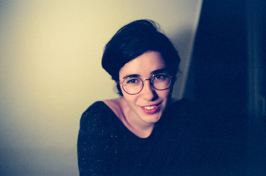 Portrait of a woman with short dark hair sitting on the floor