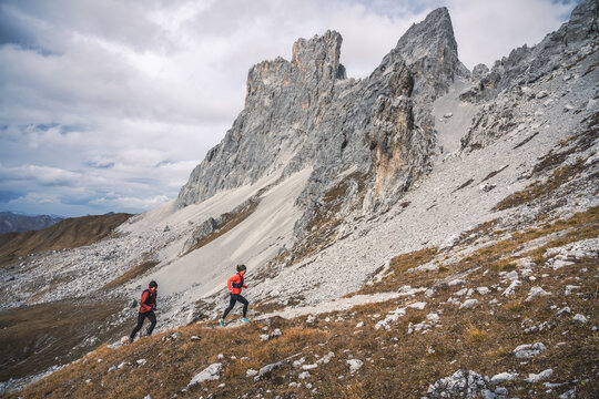 Trail runners chasing through the mountains.