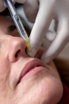 Crop woman receiving anti aging injection in salon
