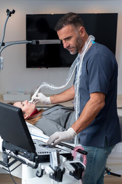 Male cosmetologist making skin care procedure to client