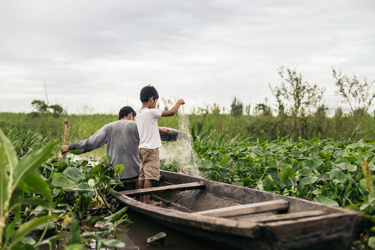Father and son fishing in the amazon river