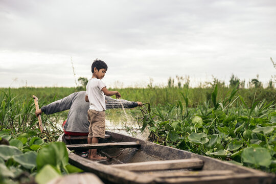 Father and son fishing in the amazon river