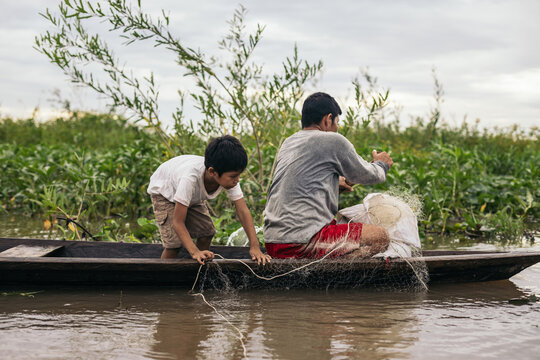 Father and son fishing in the amazon river