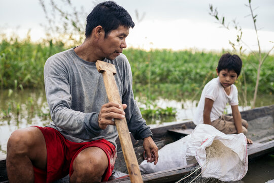 Father and son fishing in the amazon river