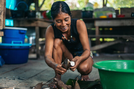Peruvian woman preparing yucca