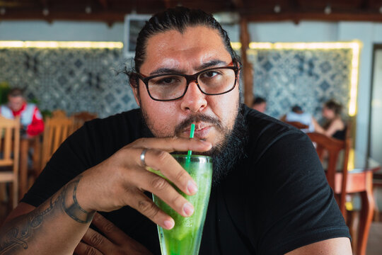 Fat man having a drink
