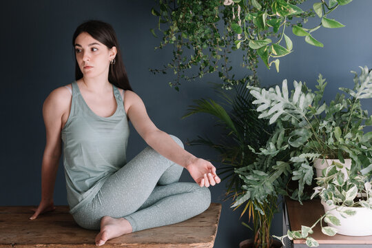 Yoga Teacher Practicing In Zen Studio On Wooden Table
