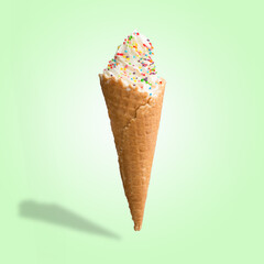 Vanilla ice cream with sweets in a waffle cone. Bright color, summer mood.