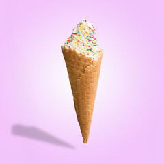 Vanilla ice cream with sweets in a waffle cone. Bright color, summer mood.