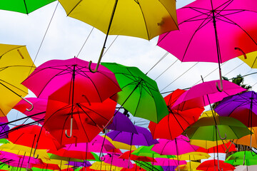 Fototapeta na wymiar Bright, Multi Colored Umbrellas hanging over Downtown San Diego, California