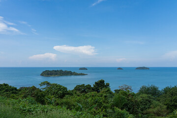 Many small islands overgrown with forests in the tropical sea.