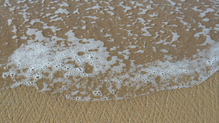 Espuma de mar sobre arena