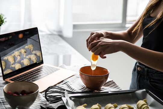 Crop woman breaking egg for pastry