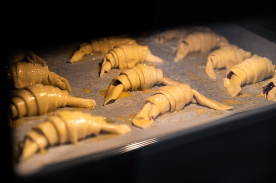 Fresh croissants baking in oven