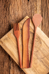Fototapeta na wymiar Wooden cutlery on wooden table.