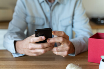 Close-up of man checking smartphone