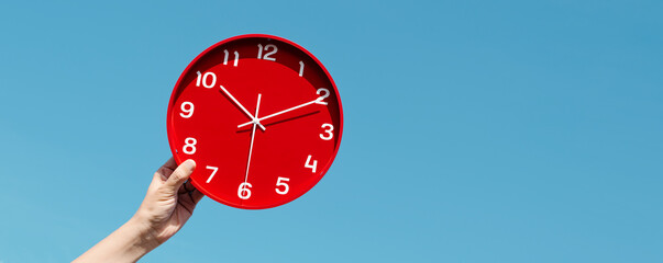 man holds a red clock, web banner format