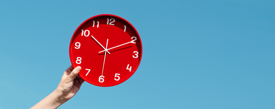 man holds a red clock, web banner format