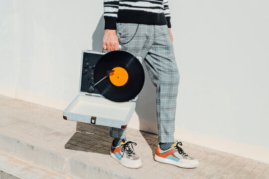 man carrying a portable turntable
