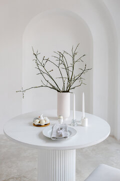 Table setting for Easter in room with arch wall